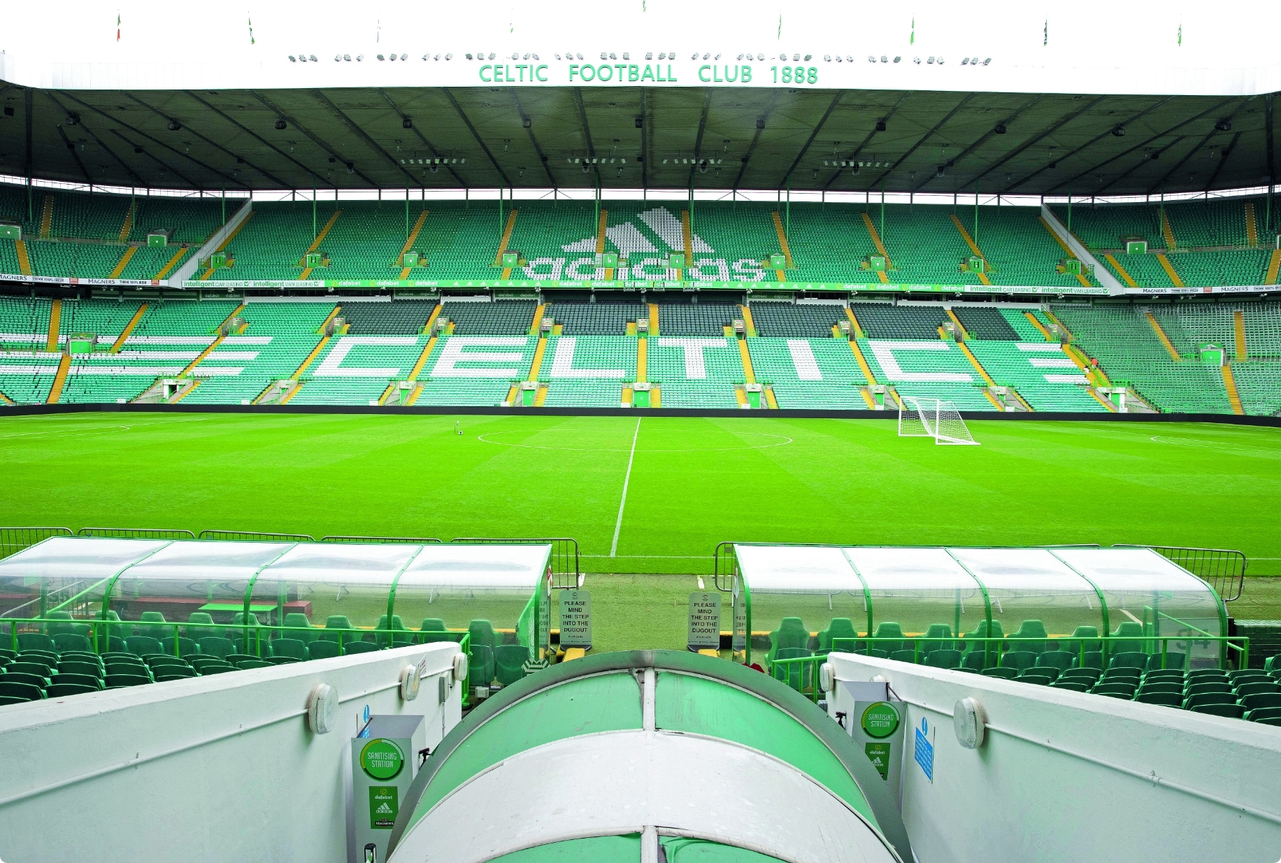 Close up of Celtic Football Ground with green stands spelling celtic in the chairs.